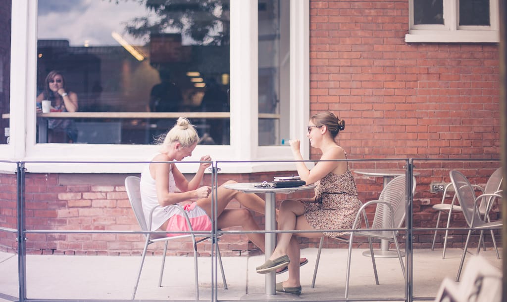 Two women sitting at a cafe and talking