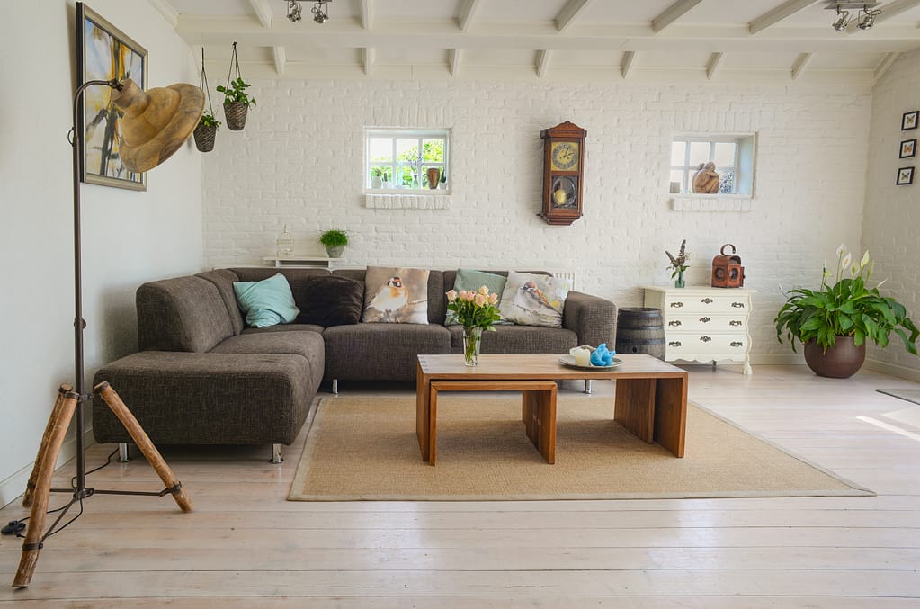 Tidying up your house as part of your daily healthy habits and a clean room with a nice couch and coffee tables
