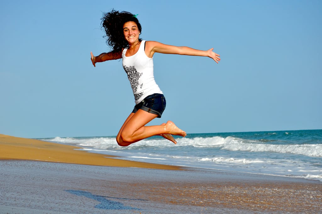 A woman jumping by the ocean