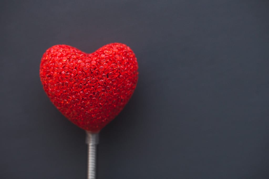 A heart shaped ballon on a stick