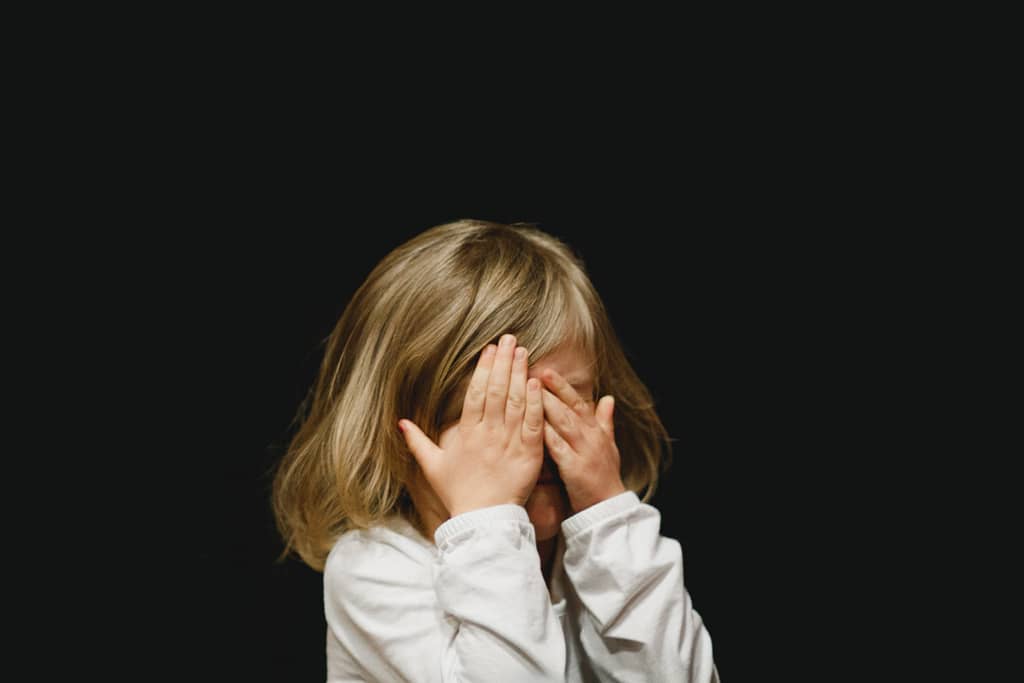 A child covering their eyes during the coronavirus lockdown