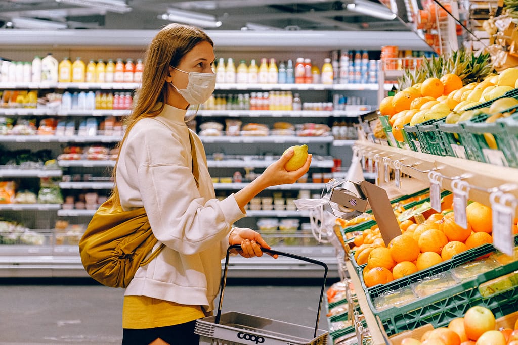 Woman wearing a mask grocery shopping