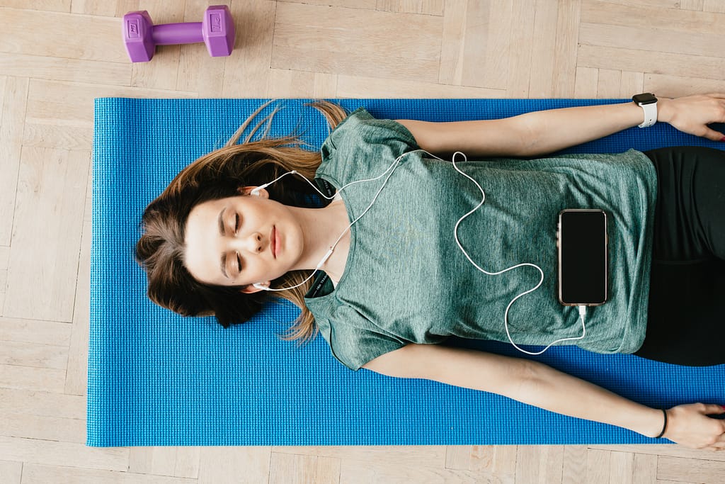Woman practicing meditation with headphones on