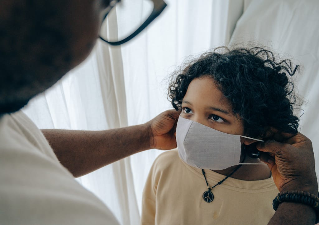 A man putting on a mask on a child