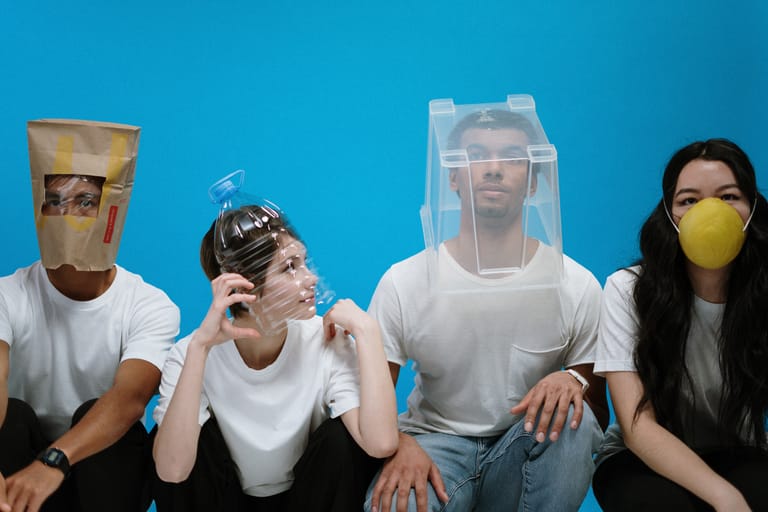 Four people with various types of masks on their face