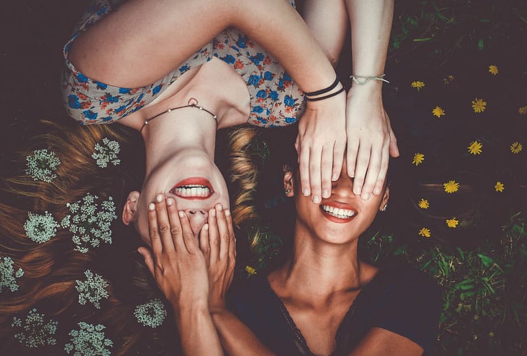 How to stop comparing yourself to others: two women closing each other's eyes