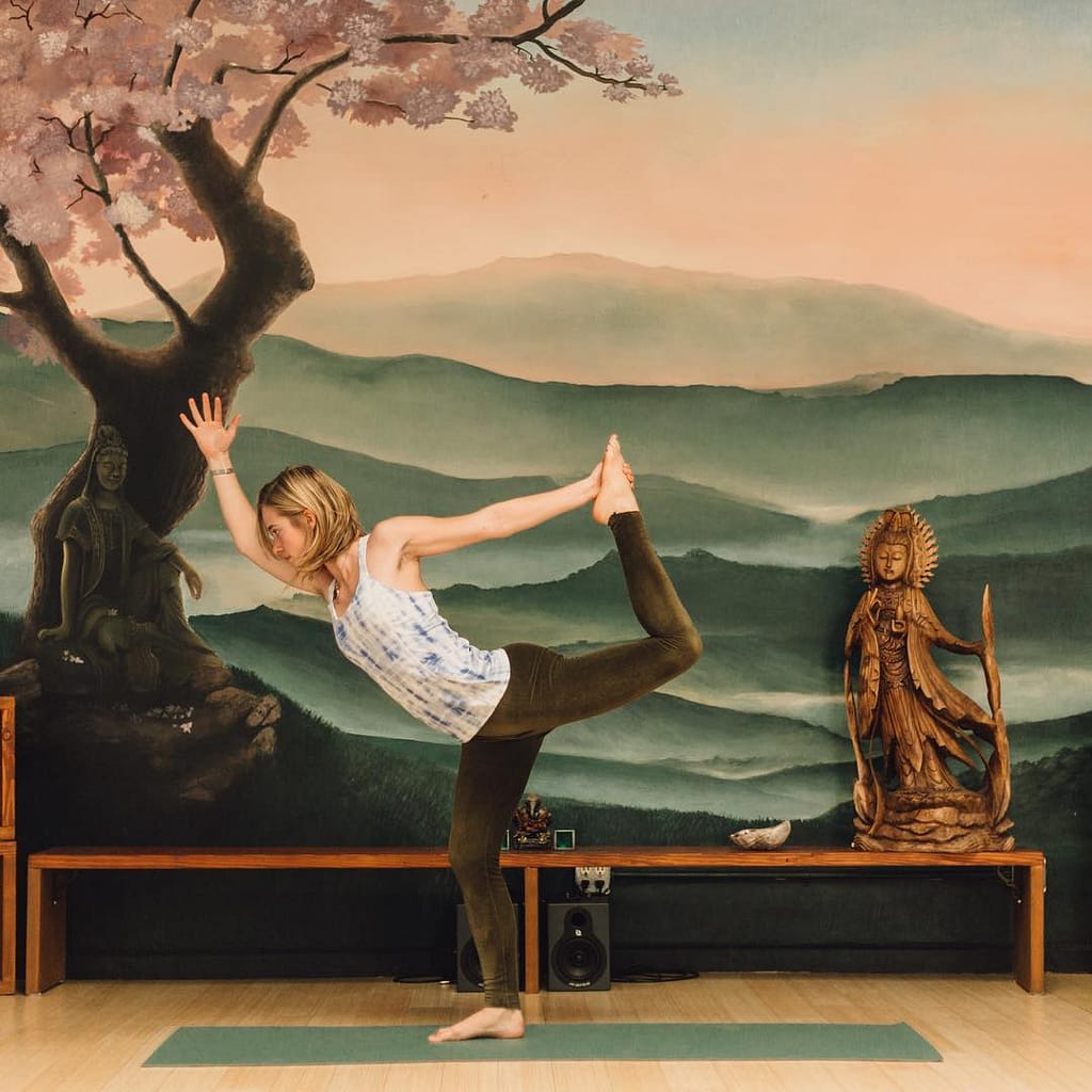 Sierra Noland practicing yoga in dancers pose