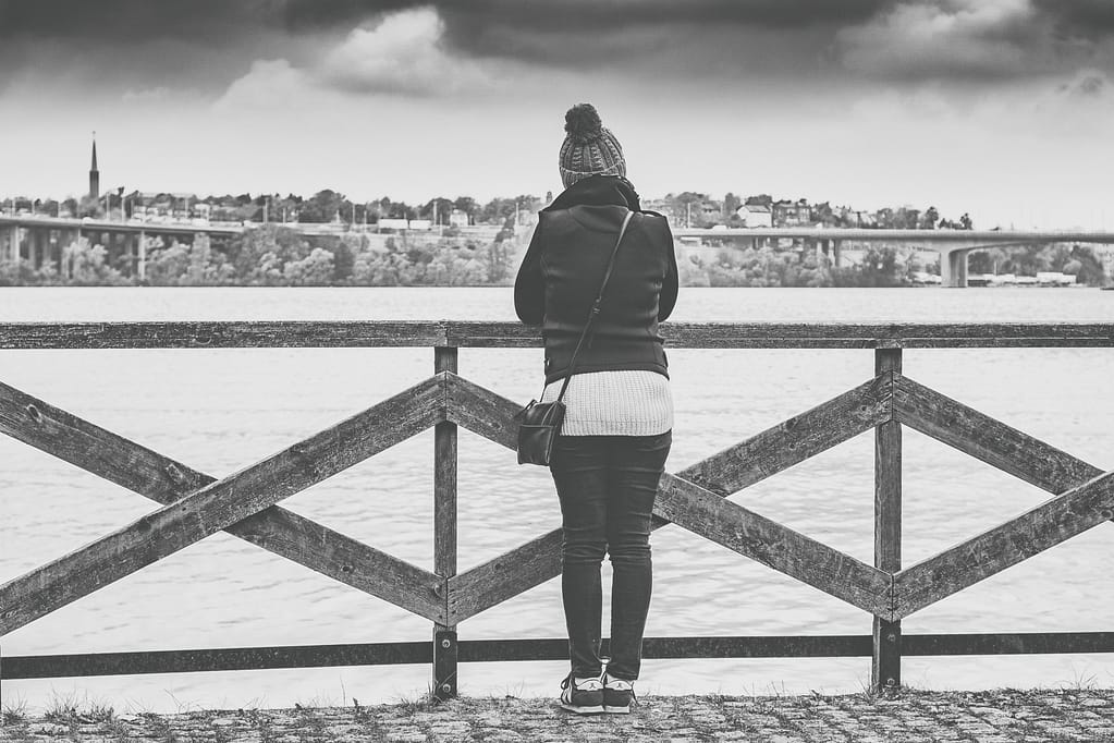 Woman standing by a bridge