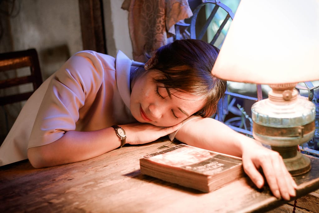 A woman sleeping on her desk