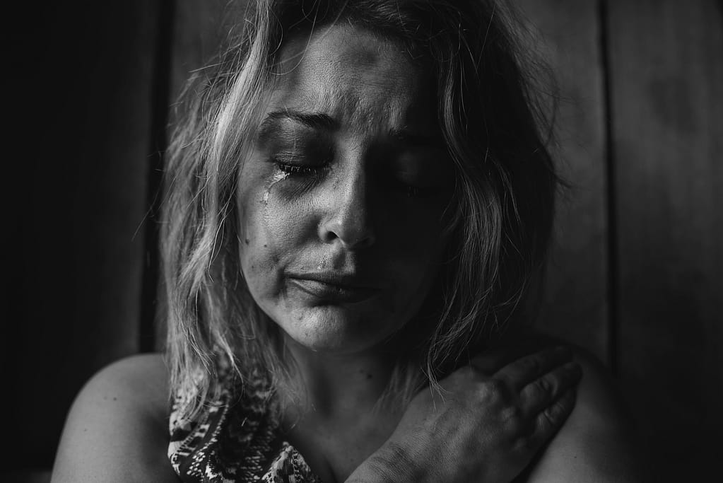 A woman crying and feeling grief and loss