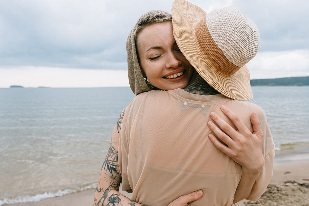 A woman hugging another person in gratitude