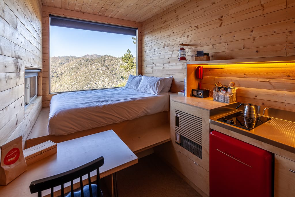 Getaway House Big Bear cabin interior with small kitchenette and chair