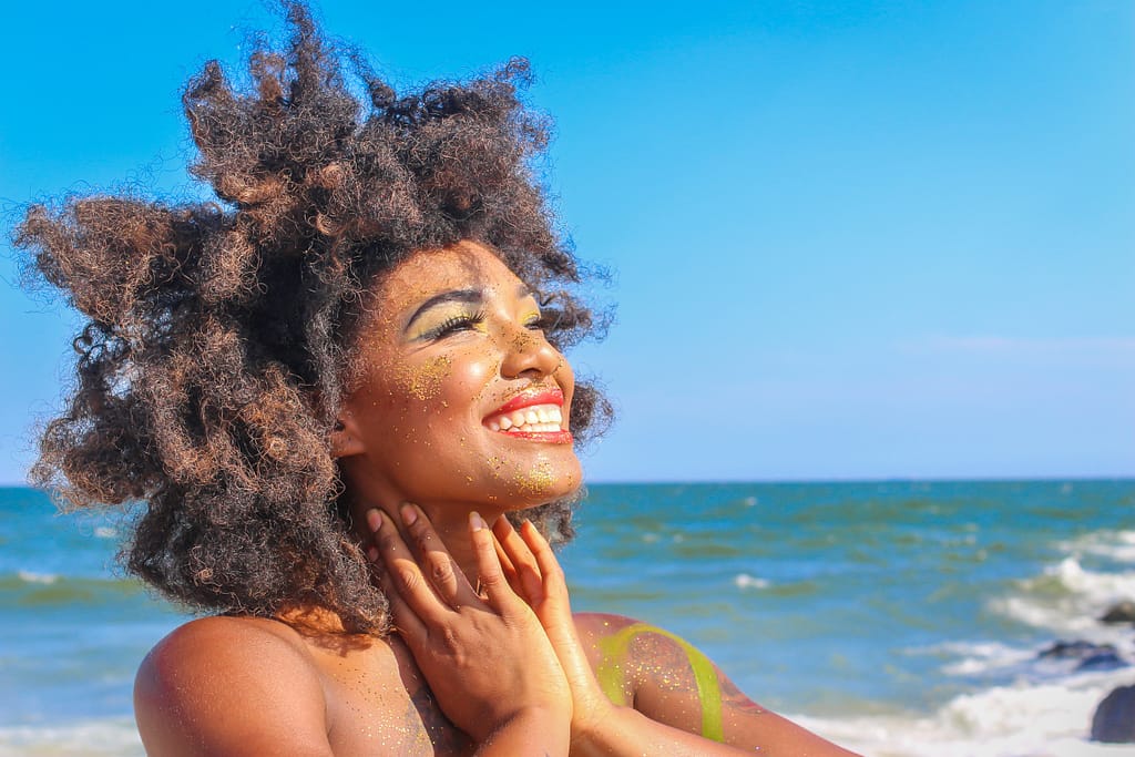 How to be happy: a beautiful woman smiling on the beach