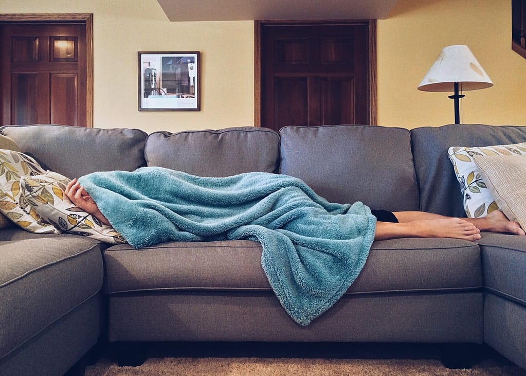 A person sleeping on a couch