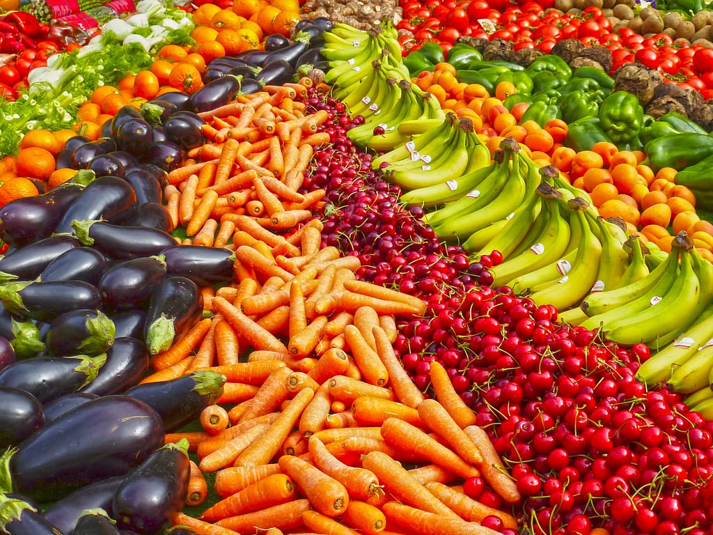 Abundance of produce like bananas, carrots, eggplant, cherries and more